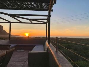 a view of the sunset from the patio of a house at Elands One in Elands Bay
