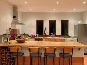 a kitchen with a large wooden island with bar stools at Elands One in Elands Bay