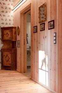 an empty room with a wooden wall with a mirror at Wohnung ASSUNTA in Soprabolzano