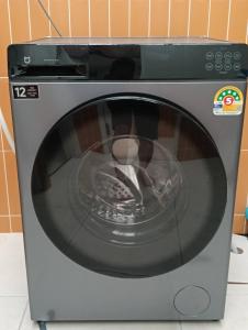 a microwave oven with its door open in a kitchen at Nitra Hostel ladies Only in Bangkok Noi