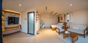a living room with a couch and a bed at Atana bidiyah private camp in Al Raka