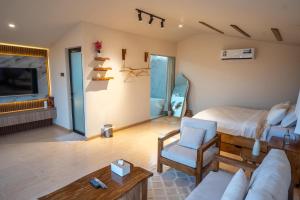 a living room with a bed and a couch at Atana bidiyah private camp in Al Raka