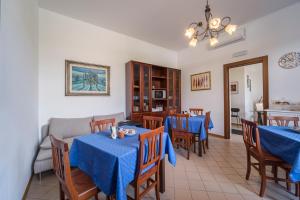 una sala da pranzo con tavoli e sedie blu di IL VIVAIO Bed and Breakfast a Santa Teresa di Riva