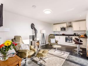 a living room with chairs and a fire place at 1 Bed in Combe Martin 77349 in Loxhore +9 photos