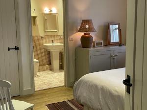 a bedroom with a bed and a bathroom with a sink at 1 Bed in Ullswater 94065 in Watermillock