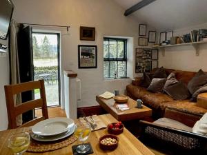 a living room with a couch and a table at 1 Bed in Ullswater 94066 in Watermillock