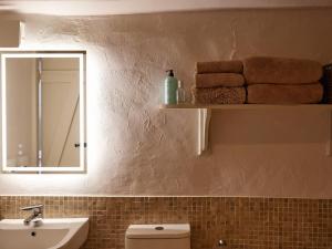 a bathroom with a sink and a mirror and towels at 1 Bed in Ullswater 94066 in Watermillock