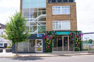 a building with flowers on the front of it at Best Western Northfields Ealing Hotel -Northfield station Elizabeth line in London