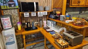 a kitchen with a counter with a table with food at Hosteria Chalp in Ushuaia