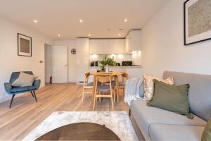 a living room with a couch and a table at Fabulous 2BR Apartment at Trinity Point Gravesend in Gravesend