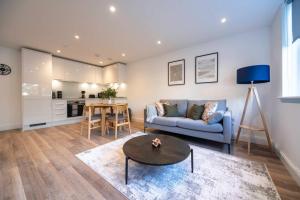 a living room with a couch and a table at Fabulous 2BR Apartment at Trinity Point Gravesend in Gravesend +28 photos