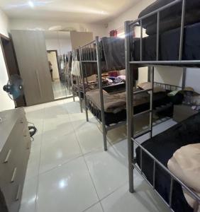 a room with several bunk beds and a mirror at Girls Only Shared Room Gzira #3 in Il-Gżira