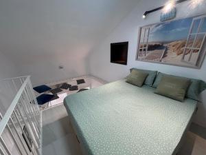 a bedroom with a bed and a crib in it at Carihuela Home in Torremolinos