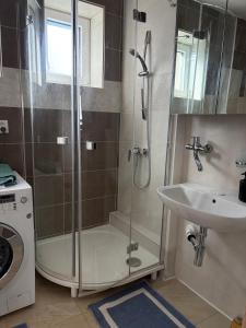 a bathroom with a shower and a sink at Villa appartment in Vinohrady +12 photos