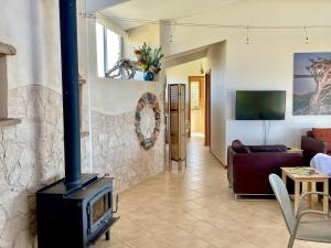 a living room with a fireplace and a couch at Moonrise Cove in Pelican Lagoon