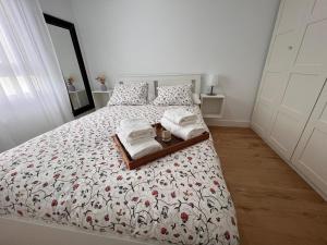a bedroom with a bed with two towels on it at Casa Rural Las Candelas in San Vicente de Alcántara