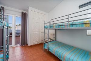 1 Schlafzimmer mit 2 Etagenbetten und einem Balkon in der Unterkunft Villa Prainha in Alvor + 24 Fotos