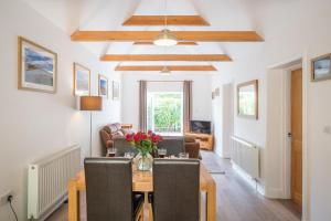 a living room with a dining table and chairs at Greenacres, Kelsale in Kelsale
