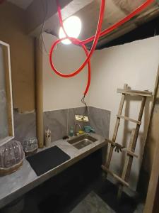 a red hose hanging over a sink in a room at Tsinoy Villa in Pandi