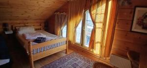 a small bedroom with a bed and a window at Family Home in Fáskrúðsfjörður