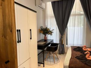 a bedroom with a desk and a bed and a desk at Casa Luna beach side Luxurious comfy apt in center Paphos in Paphos