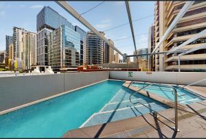 a swimming pool on the roof of a building at Centre CBD - Pool Spa Gym - Water View - Sleep 4 in Brisbane