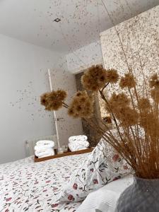 a bedroom with a bed with flowers on it at Casa Rural Las Candelas in San Vicente de Alcántara