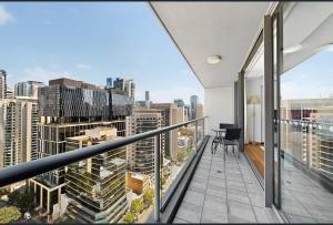 a balcony with a view of a city at Centre CBD - Pool Spa Gym - Water View - Sleep 4 in Brisbane