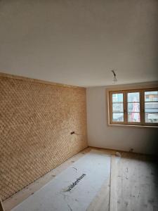 an empty room with a wall and a window at Bartles Hus in Mellau
