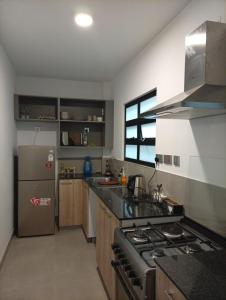 a kitchen with a stove and a refrigerator at 2 Bed Inside Tilisi 