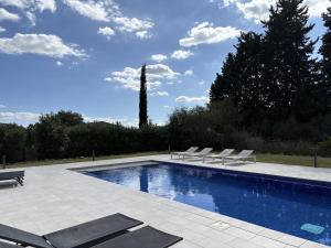 a swimming pool with lounge chairs next to at Trebol in Sa Pobla