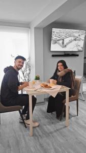 a man and woman sitting at a table with food at Hotel Ágora in Viña del Mar +30 photos