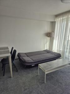 a room with a bed and a table and a desk at Lux 1960 in Banská Bystrica