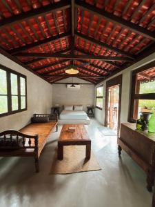 a living room with a bed and a table at Vagabond Collective - Coliving & Coworking in Weligama