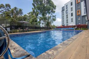 a swimming pool in front of a building at 2 Bed Inside Tilisi 