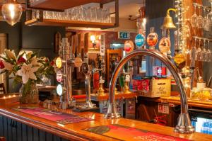 a bar with a sink in a pub at The Cowdray Arms in Worth