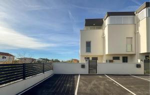 a building with a parking lot in front of it at Cozy Home In Privlaka With Wifi in Glavan +9 photos