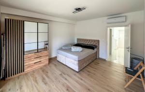 a bedroom with a bed and a sliding glass door at Cozy Home In Privlaka With Wifi in Glavan