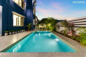 a swimming pool in the backyard of a house at EKO STAY Gold - Gatsby Villa in Lonavala