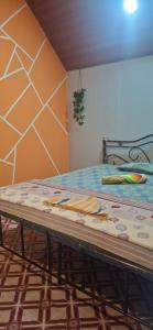 a bed in a room with a table in it at green Garden Resort in Canacona
