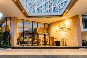 a store front of a shopping mall with glass doors at Montien Hotel Surawong Bangkok in Bangkok