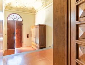 an empty room with a wooden door and a window at Silvia's house in Marina di Pisa