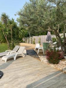 a patio with two lounge chairs and a umbrella at Chez Pat et Dom in Aix-en-Provence