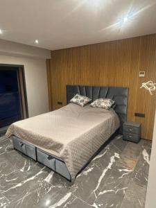 a bedroom with a large bed with marble floors at Elite garden in Marrakech
