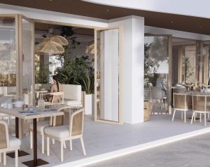 eine Frau, die an einem Tisch in einem Restaurant sitzt in der Unterkunft Considero Hotels Maldives - Thoddoo in Thoddoo-Atoll