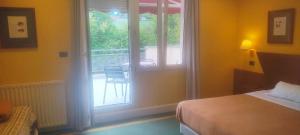 a bedroom with a bed and a window with a balcony at Habitación triple con bañera y terraza HOTEL SUITE MIOÑO in Castro-Urdiales