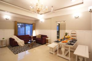 a living room with a table with food on it at Ekostay Gold - Olive Crest Villa - Spacious Lawn in Lonavala