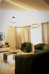 a living room with two chairs and a coffee table at A1 Pinnacle Serviced Apartment in Oshogbo