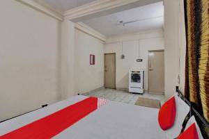 a room with a bed with a red blanket at Hotel O Kr Inn in Chandrapur