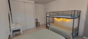 a bedroom with a bunk bed with lights on it at logement familial spacieux, 2 chambres , grand salon in Fougères